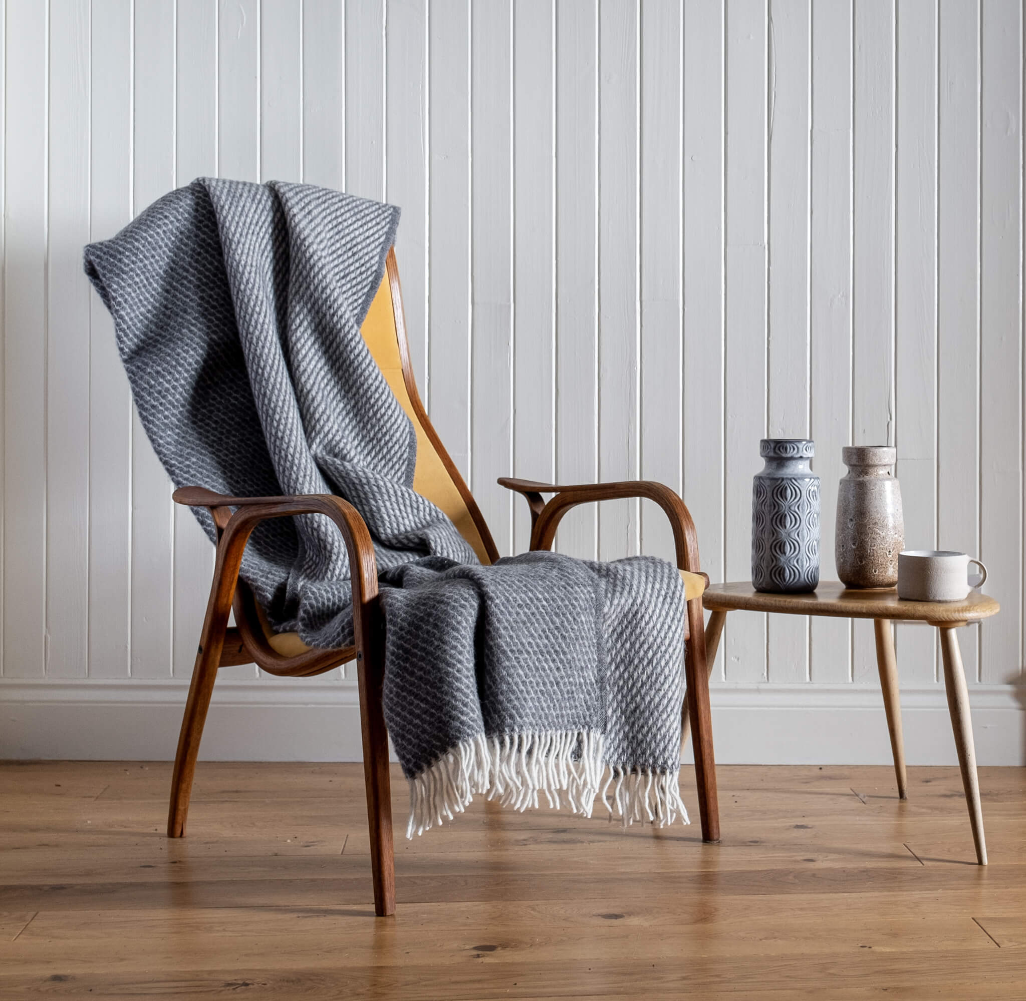 Honeycomb Wool Blanket – Grey, draped on a chair