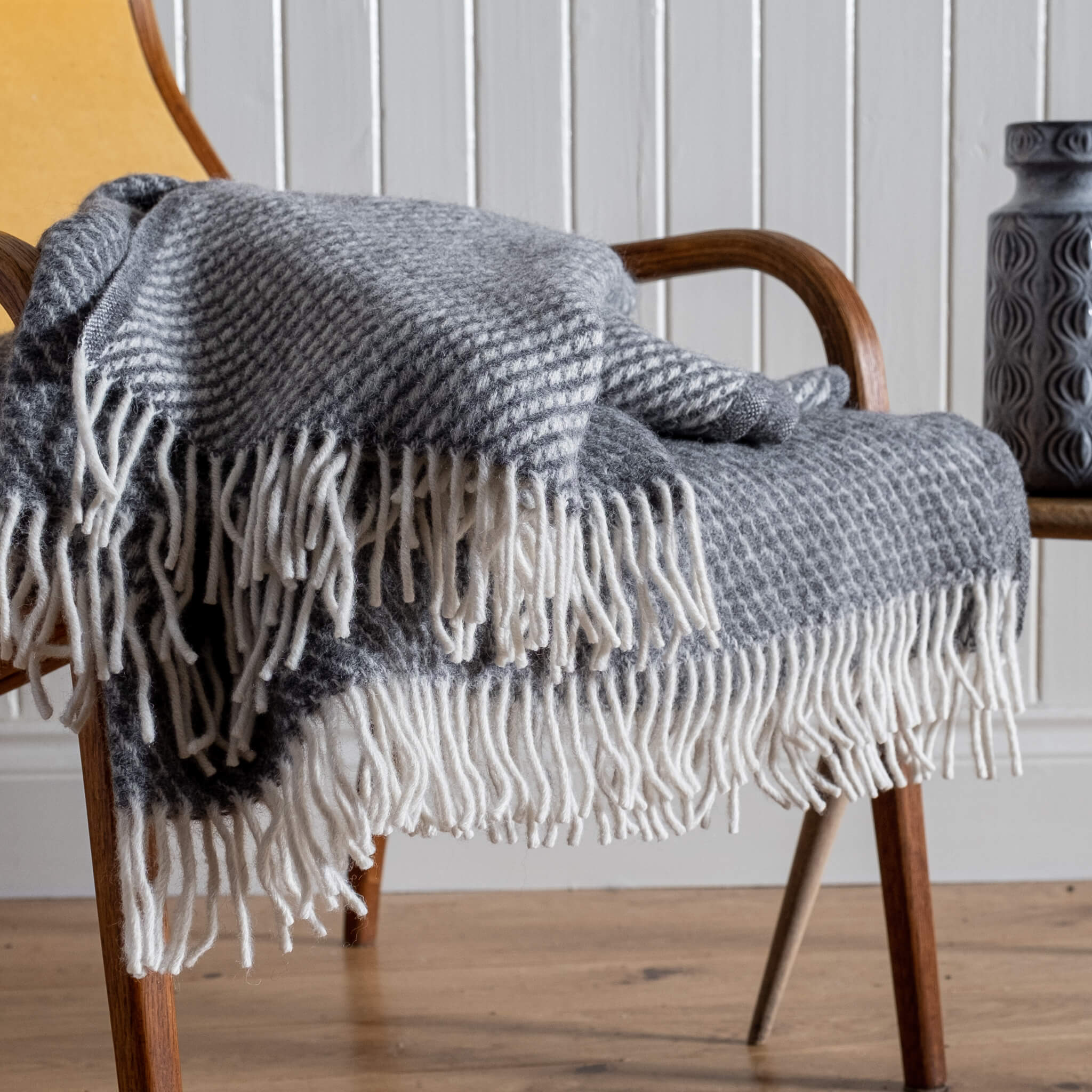 Close up of Honeycomb Wool Blanket – Grey, draped on a chair