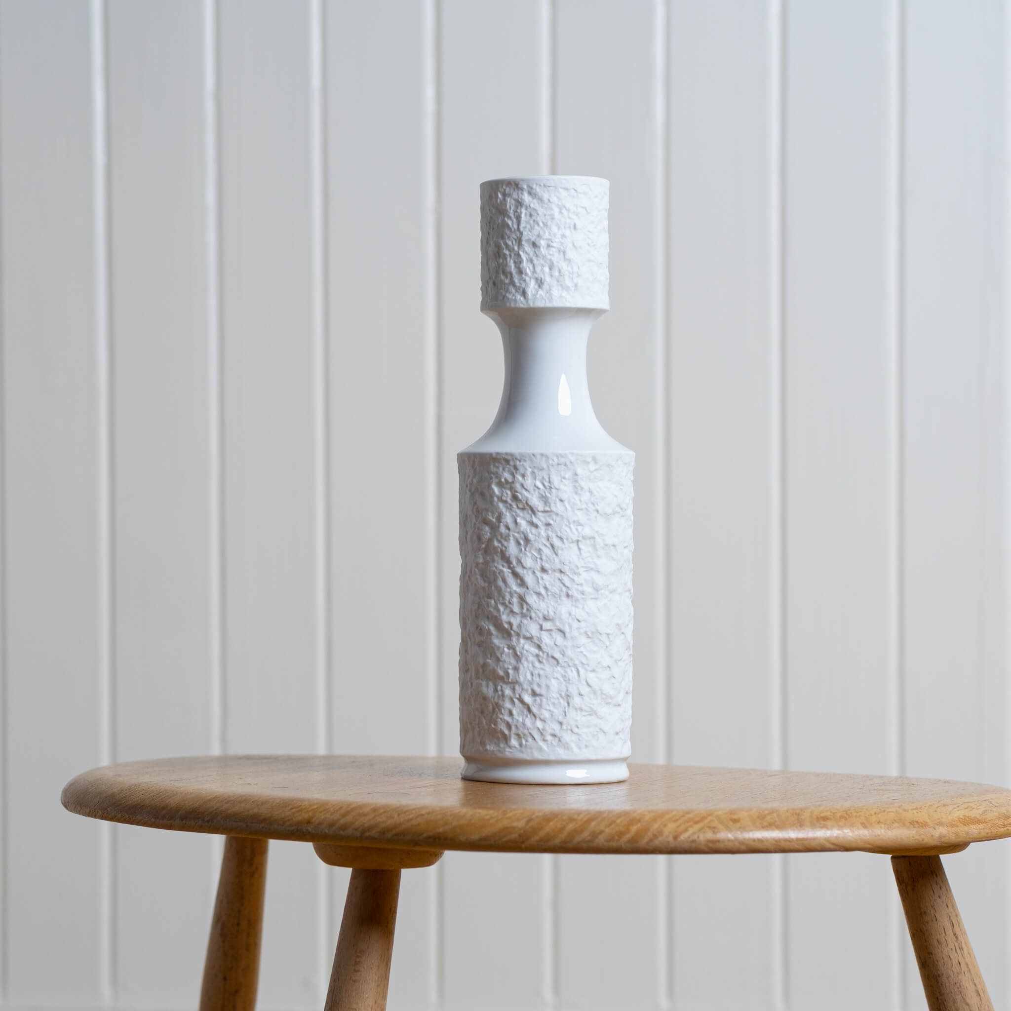 Vintage Op Art Royal KPM Tall Textured Vase with white matt bisque glaze on a table