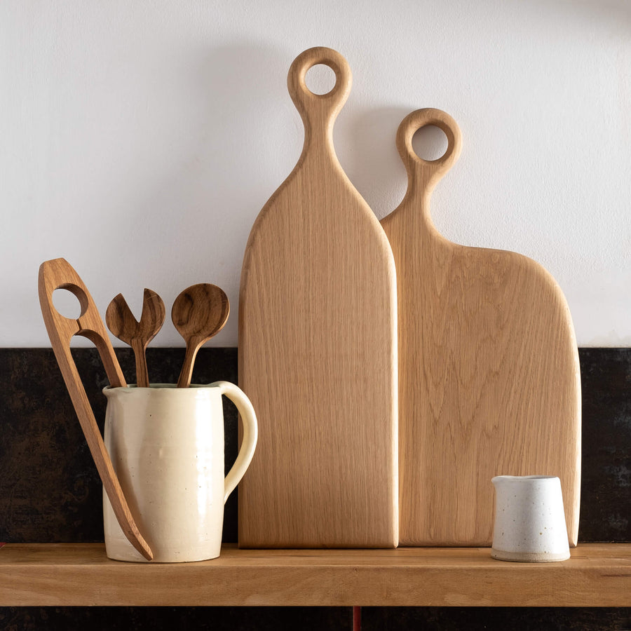 Forge Creative Long & Wide Oak Chopping Board on shelf with small jug and utensils