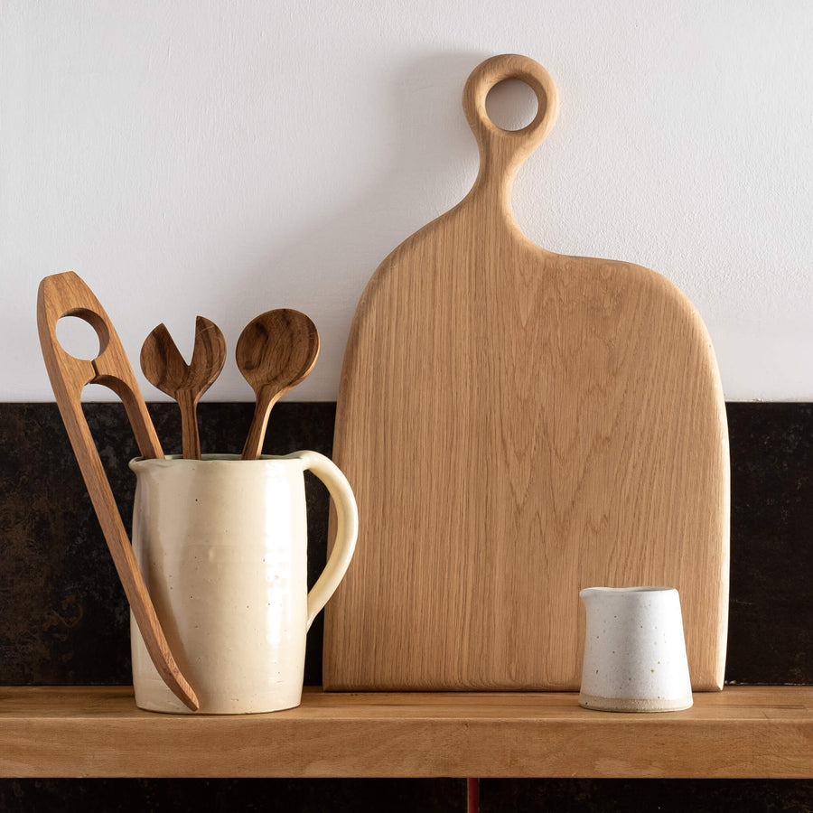 Forge Creative Wide Oak Choppng Board on shelf with small jug and wooden utensils
