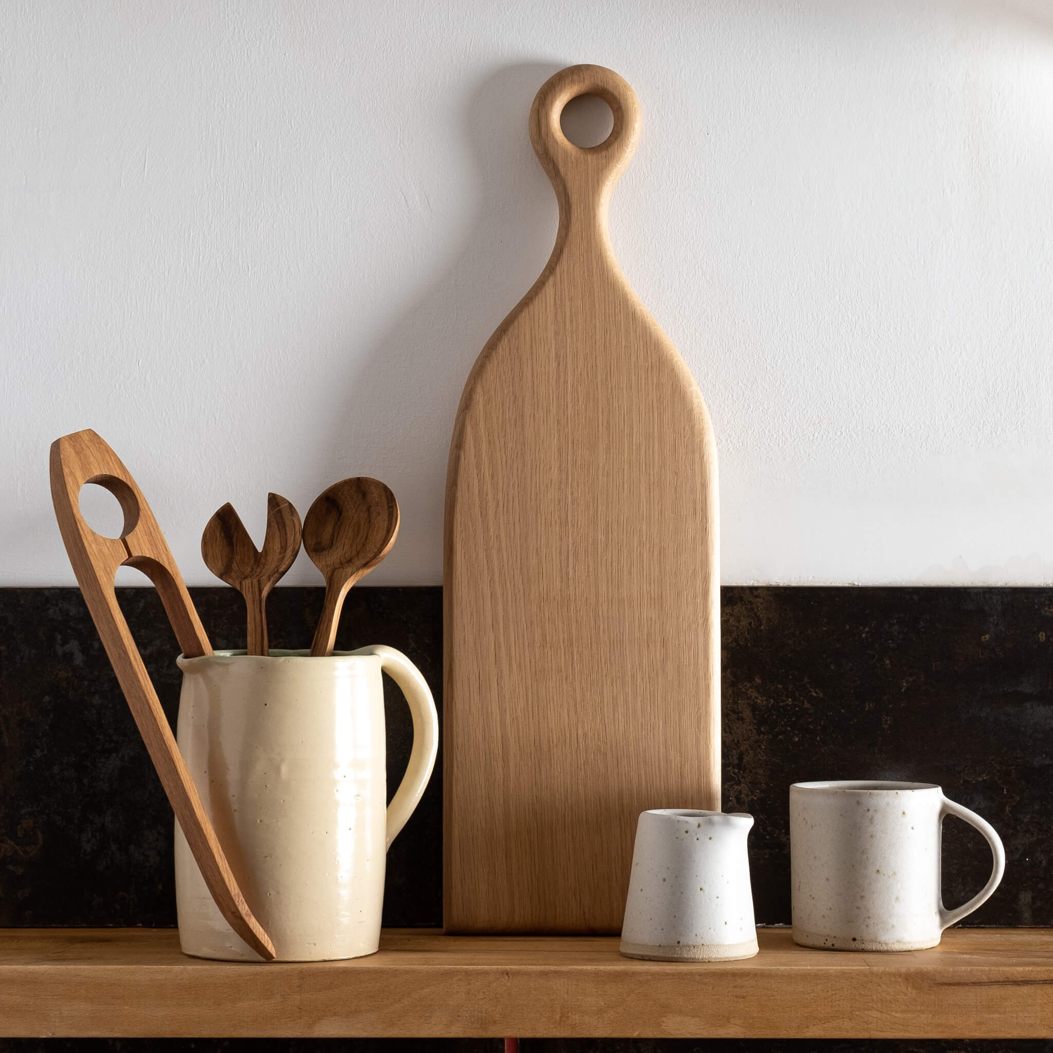 Forge Creative Long Oak Chopping Board on shelf with small jug, mug and utensils