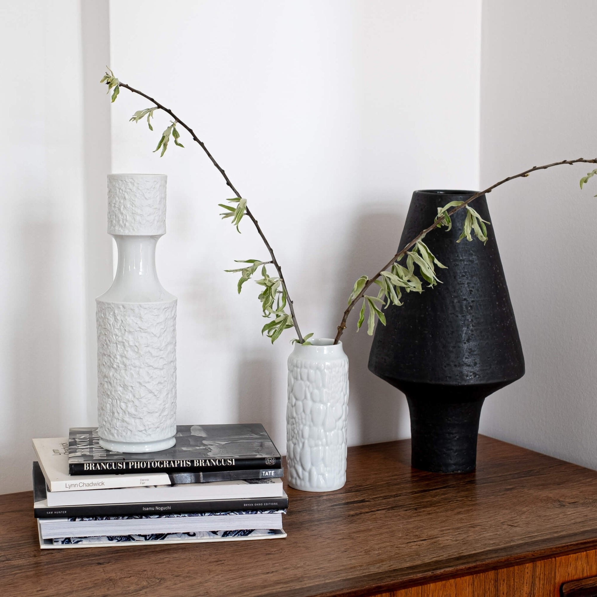Lifestyle shot of two Vintage Op Art vases with relief patten on the white glaze